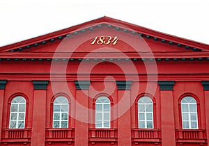 Red facade of Kiev National University with semicircular white windows