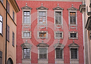 Red facade of palace w windows, Stockholm Sweden