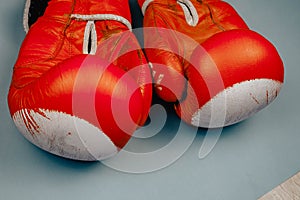 red faded boxing gloves on blue background