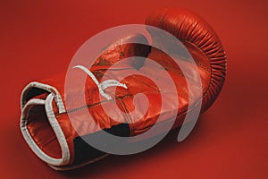 red faded boxing gloves on red background