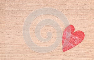 Red faded heart on wooden board