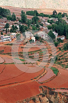 Red farmland with village in dongchuan of china