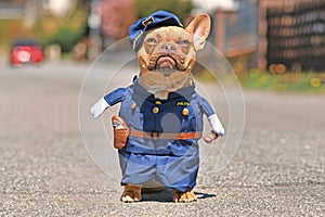 Red fawn French Bulldog dog wearing funny police officer uniform costume with fake arms