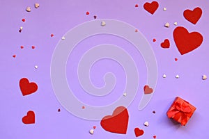 Red felt hearts and present box on pink background. Valentine& x27;s Day gift or greeting card concept