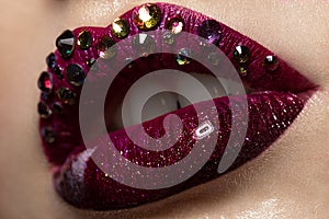 Red female art lips with rhinestones close-up. Beauty face. photo