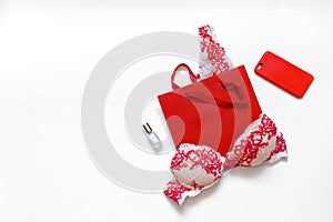 Red female erotic underwear and female accessories on a white background. Place for text. Gift concept for beloved woman