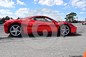 Red Ferrari with mirror paint on a track in Florida