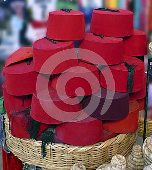 Red Fez tarbouche and white wicker tagine cookers