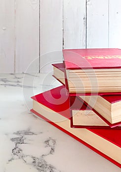 Red fiction,novels are stacked on marble floors, white wood wall backgrounds