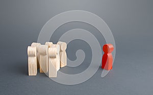 Red figurine person and crowd of people standing separately. Leader and leadership skills. Cooperation, collaboration. Fear