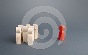 Red figurine person and crowd of people standing separately. Leader and leadership skills. Cooperation, collaboration. Fear photo