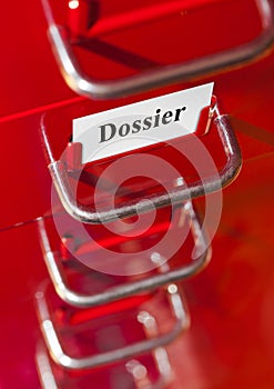 Red file cabinet with card Dossier