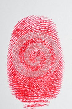 Red fingerprint on white paper