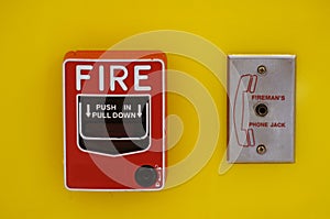 Red Fire alarm pull station Switch install on bright yellow wall