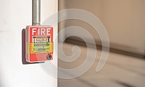 The red fire alarm switch on the white wall in the everywhere in public area for the security first and alert when the being fire