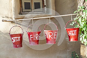 Red fire buckets filled with sand