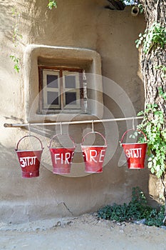 Red fire buckets filled with sand