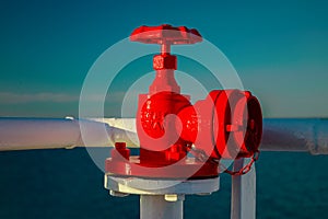 Red fire cock, fireplug on a ship