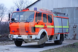 Red fire engine car parked with emergency ladder