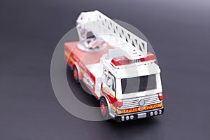 Red fire engine toy on black background