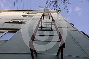 Red fire escape on the facade of a residential building.