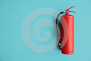 Red Fire extinguisher on the blue wall. photo