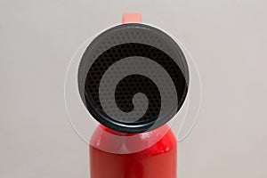 Red Fire Extinguisher in Front of Grey Background