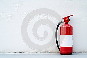 fire extinguisher on white wall, close up
