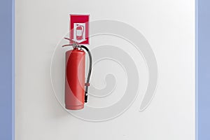 Red Fire extinguisher on the white wall background