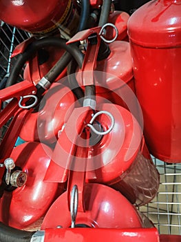 Red fire extinguishers. Many red fire extinguishers on the ground. Foam, Carbon dioxide, Powder and Water