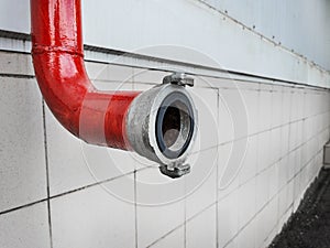 Red fire-fighting pipeline with a close-up lock