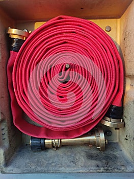 red fire hose with bronze nozle