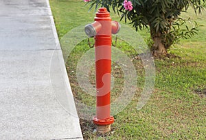 Red fire hydrant against a green lawn