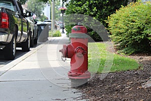 A red fire hydrant on a sidewalk