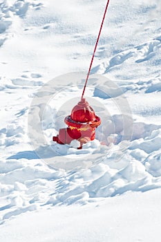 Red fire hydrant sunk in snow photo