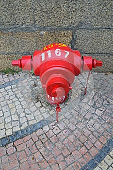 Red Fire Hydrant on Traditional style Portuguese Calcada Pavement