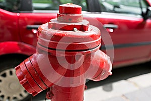 Red fire hydrant water pipe near the road. Fire hydrant for emergency fire access