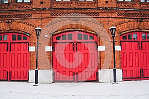 Red Fire Station doors on red brick wall building