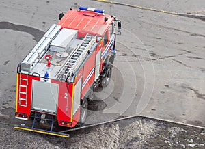 Red fire truck with emergency lights, saving people, threat to life, background, department