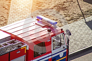 Red fire truck with emergency lights, saving people, threat to life, background, department