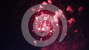 Red fireworks exploding in the night sky during a celebration