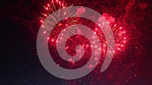 Red fireworks exploding in the night sky creating a beautiful show
