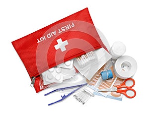 Red first aid kit with scissors, pins, cotton buds, pills, plastic forceps, medical plasters and elastic bandage isolated on white