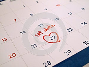 Red first Date marked on white calendar agenda target date for romance and dating