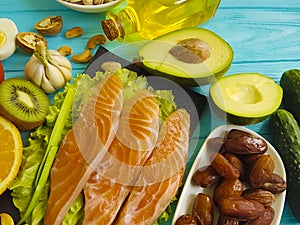 Red fish, avocado, organic nuts lemon delicious vegetable on a blue wooden background, healthy food fresh