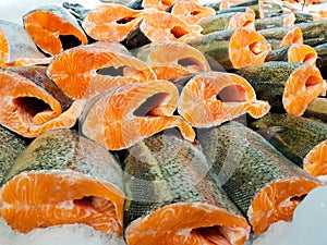 Red fish fillet in ice close up