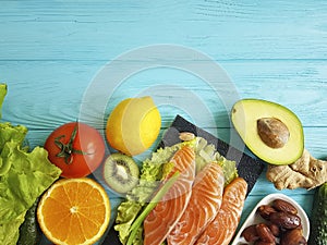 Red fish omega 3 , fresh avocado nuts assortment on blue wooden, composition healthy food