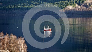 Red Fishing boat in Eide on autumn day on Atlantic Road in Norway