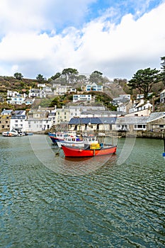 Red Fishing boat moored in the historic and quaint Polperro Harbour in Cornwall