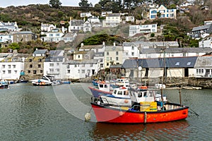 Red Fishing boat moored in the historic and quaint Polperro Harbour in Cornwall, UK